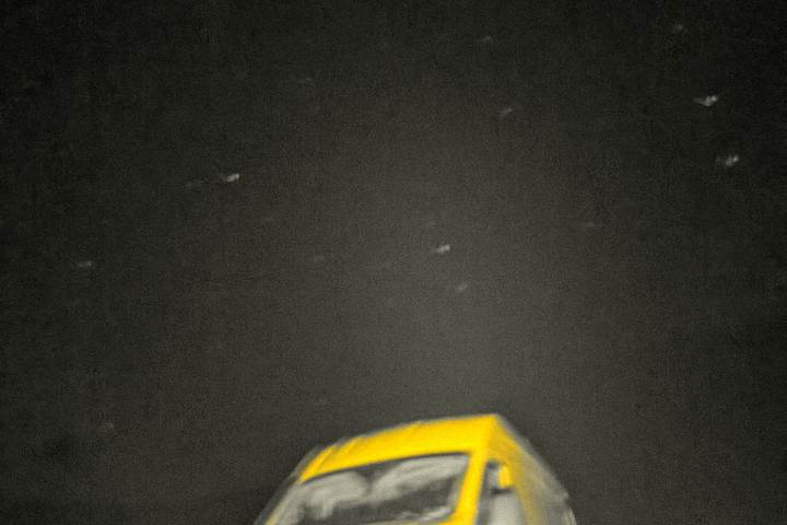 The van head-on at night through rain on the glass
